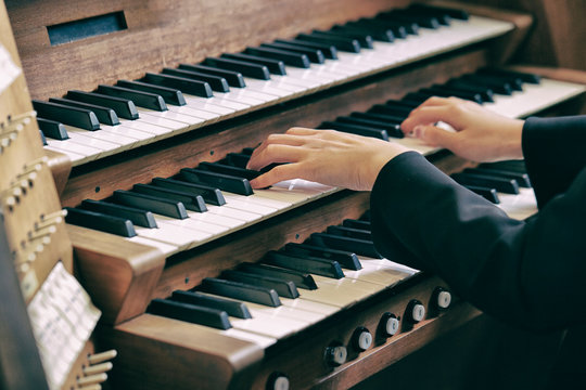 A woman playing the pipe organ 