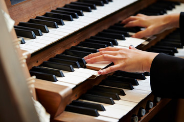 A woman playing the pipe organ 