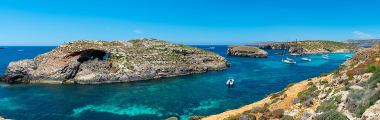 Stone cliffs on the blue lagoon of the island of Comino and Gozo Malta. Mediterranean Sea