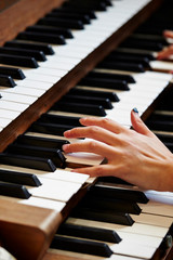 Fototapeta premium A woman playing the pipe organ 