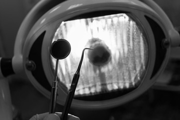 In the dentist's office - fear and distrust of the patient before dental treatment. Black and white image.