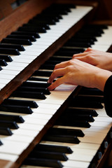 A woman playing the pipe organ 