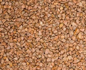 Vue gros plan d'une texture de pierre, gravier et sable fin orange et marron