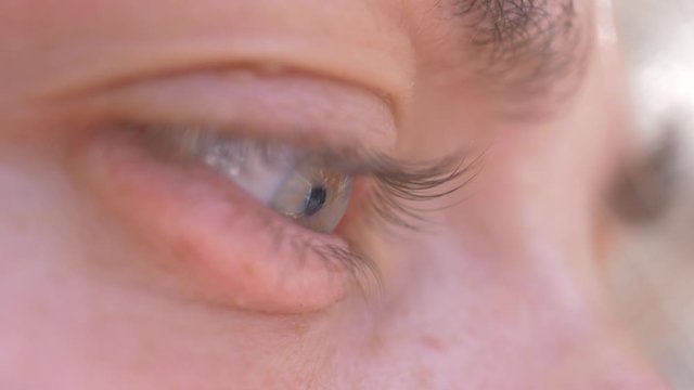 Macro of woman eye, gren and blue clored eye close up