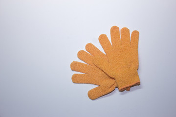 Exfoliating massage glove for shower on white background