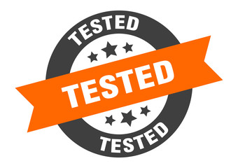 tested sign. tested orange-black round ribbon sticker