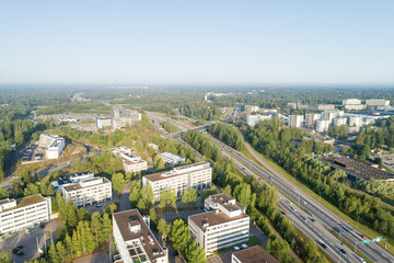 Fototapeta na wymiar Aerial Drone Flight Photo of highway with cars and trucks. Road Junction in the big city. Top view. Cityscape in sunset soft light. Finland, Espoo, Europe