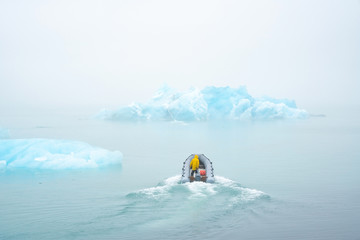 scientists on the boat study the melting of icebergs due to global warming