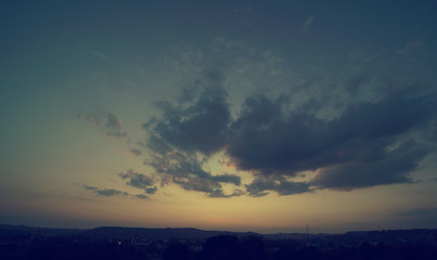 Beautiful sunset sky above clouds with dramatic light.
