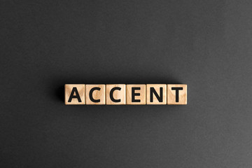 accent - word from wooden blocks with letters, the way to  pronounce words accent concept, gray...