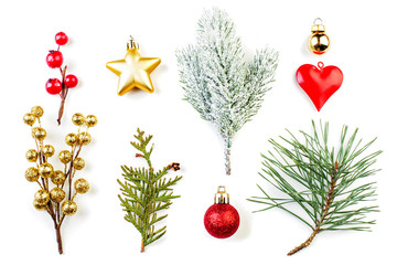 Beautiful Christmas composition. Red holly berries, golden star, glass baubles and green fir branch isolated on white background