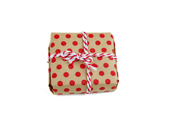 Tiny gift box tied with stripy white-red lace isolated on white background