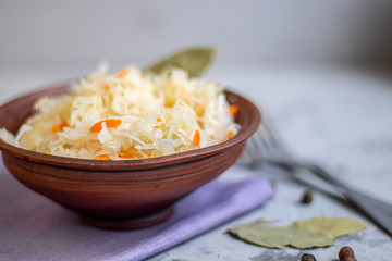 Plate with sour cabbage.  This is a useful fermented product.  Sour cabbage is rich in vitamins and is used in many dishes of different nations.  The fermentation process does not destroy nutrients.  