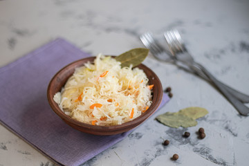 Plate with sour cabbage.  This is a useful fermented product.  Sour cabbage is rich in vitamins and is used in many dishes of different nations.  The fermentation process does not destroy nutrients.  