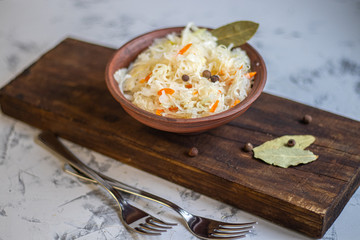 Plate with sour cabbage.  This is a useful fermented product.  Sour cabbage is rich in vitamins and is used in many dishes of different nations.  The fermentation process does not destroy nutrients.  