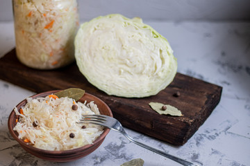 Plate with sour cabbage.  This is a useful fermented product.  Sour cabbage is rich in vitamins and is used in many dishes of different nations.  The fermentation process does not destroy nutrients.  