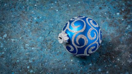 .Close-up of blue christmas ball with silver glittering pattern