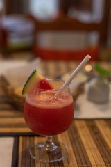 Cocktail served on a table with restaurant in the background