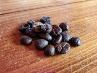 Roasted Coffe beans composition on wood background, italian espresso 