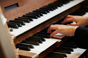 Fototapeta premium A woman playing the pipe organ 