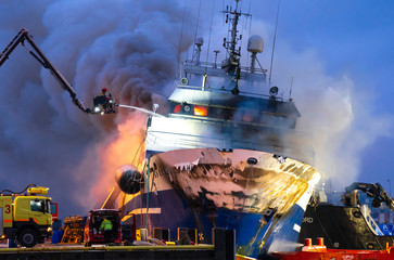 Tromso, Norway 25.09.2019 A Russian fishing trawler named "Bukhta Nayezdnik" which caught fire in Norway on Wednesday has overturned and is mostly