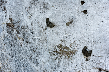 Texture of a concrete wall with cracks and scratches which can be used as a background