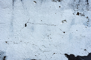 Texture of a concrete wall with cracks and scratches which can be used as a background