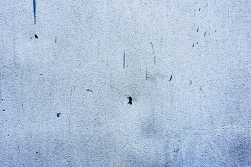 Texture of a concrete wall with cracks and scratches which can be used as a background