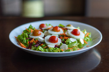 fresh and delicious green salad of lettuce tomato, carrot and heart of palm
