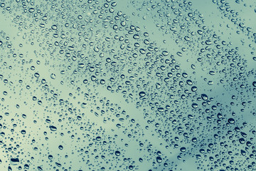 Window glass with rain droplets. Rain season concept.