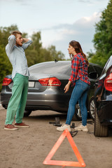 Car accident on road, man and woman are sorted out