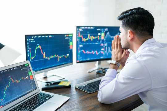 Latin Finance Professional Sitting With Hand Clasped