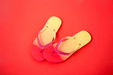Beach flip flop on red background