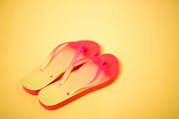 Beach flip flop on yellow background