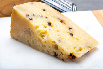 Italian aged pecorino cheese with black peppers made in region Nebrodi, Sicily, Italy