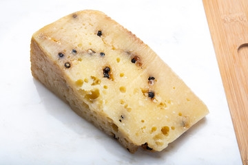 Italian aged pecorino cheese with black peppers made in region Nebrodi, Sicily, Italy
