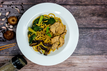 Chinese stir-fried noodles, Shiitake mushrooms, Pork and Cantonese vegetables, Hokkien noodles, Phuket's traditional food. (Top view)