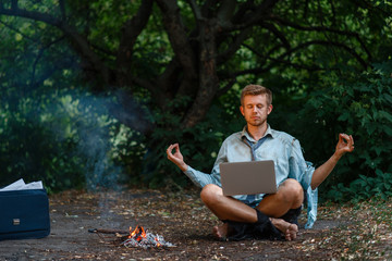 Alone businessman with laptop at fireplace, island