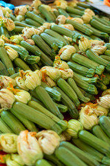 Young zicchini vegetables with yellow flowers on farmer market