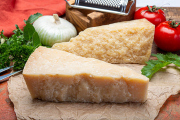 Italian original aged Parmesan cheese in two pieces close up