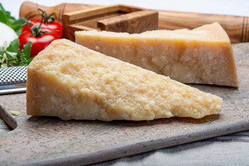 Italian original aged Parmesan cheese in two pieces close up