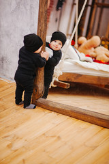 Vertical portrait of baby boy and big mirror. Beautiful little man celebrates New Year