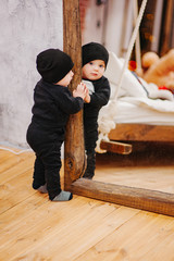 Vertical portrait of baby boy and big mirror. Beautiful little man celebrates New Year