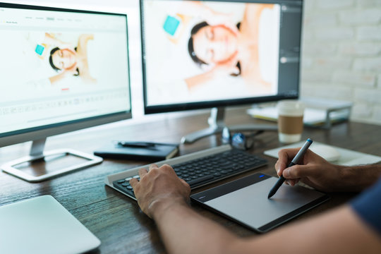 Young Male Retoucher Working At Desk