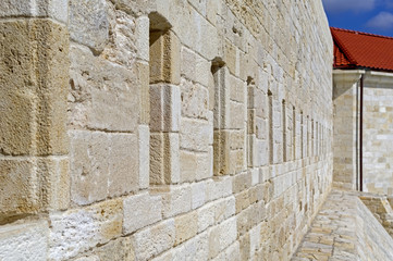 Gun loopholes in the old wall of the fortification
