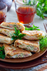Squares of fried pita bread with sausage and cheese, selective focus