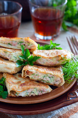 Squares of fried pita bread with sausage and cheese, selective focus