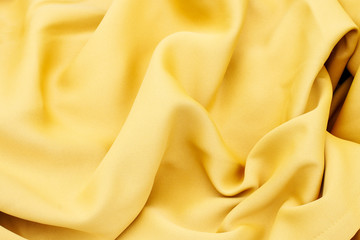 Soft yellow fabric, fashion background.