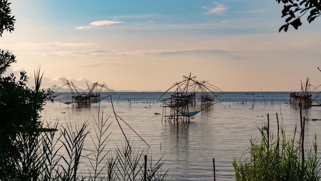 Timelapse 4K of beautiful sunrise with fishing trap in pak pra village, Phatthalung Thailand