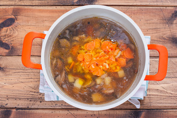 Step-by-step preparation of wild mushroom soup step 4 - adding ingredients to the soup, selective focus